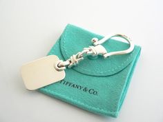 a keychain with a tag attached to it sitting on top of a card holder