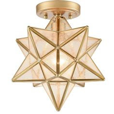 a light fixture with a star design on the front and bottom, in gold tone