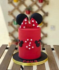 a red cake with minnie mouse ears on top