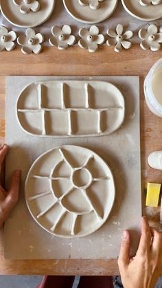 a person is working on some artisan clay pieces that have been made into flower designs