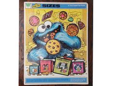 the sesame street cookie monster poster is hanging on a wooden frame with an image of cookies and doughnuts