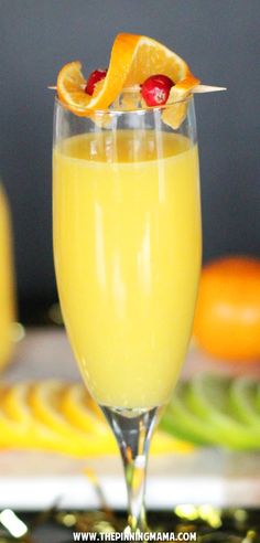 a glass filled with orange juice and garnished with an orange slice on top