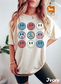 Get ready to rock that casual chic look with our 4th of July Smiley Face T-shirt ❤️ Get retro with this Graphic Tee! Featuring smiley face and a nostalgic vibe, this design is perfect for all the cool Americans out there. Show off your retro style and spread some positive vibes with this fun and funky t-shirt. ❤️ Size up, babe! Go 1-2 sizes bigger for that oversized stunner. Elevate your style, own the spotlight, and unleash your fashion power. It's time to rock the room with your effortlessly c American Retro Relaxed Fit Cotton Top, American Retro Cotton Relaxed Fit Top, American Retro Cotton Tops With Relaxed Fit, American Retro Cotton Top With Relaxed Fit, Multicolor American Flag Print Tops For Summer, American Retro Short Sleeve T-shirt For Summer, American Flag Print T-shirt For Spring, Retro American Flag Print Summer T-shirt, Casual Multicolor T-shirt For 4th Of July