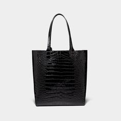 The Sarah tote from YLIANA YEPEZ blends functionality with sleek elegance. This lightweight and functional black leather tote embodies a fresh and minimalistic look that emphasizes colors and leather as means to express tradition. Embossed croc leather Front printed logo Top handle, 9.5'' (24,1 cm) drop Detachable leather pouch Open-top tote Height: 13.5'' (34,2cm) Width: 11.5'' (29,2cm) Depth: 5.5'' (14cm) Imported. Made in Europe Cleaning and Care Our products are made of the highest quality m Modern Black Bags With Crocodile Pattern, Modern Black Shoulder Bag With Crocodile Pattern, Modern Black Crocodile Pattern Shoulder Bag, Modern Shoulder Bag With Crocodile Pattern For Daily Use, Chic Workwear Bags With Crocodile Pattern, Chic Crocodile Pattern Shoulder Bag For Work, Modern Crocodile Pattern Shoulder Bag For Daily Use, Modern Crocodile Pattern Tote Shoulder Bag, Rectangular Crocodile Pattern Work Bag