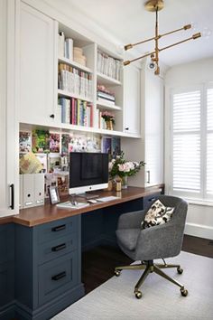 a home office with white cabinets and blue desks, along with an area rug on the floor