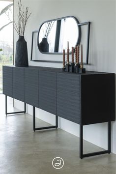 a large mirror sitting on top of a wooden dresser