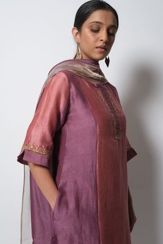 Plum pink panelled kurta highlighted with zardozi embroidery, round neckline and straight silhouette. Comes with cotton silk pant, chanderi dupatta and inner slip.
Component: 4
Pattern: Embroidered
Type Of Work: Zardozi
Neckline: Round
Sleeve Type: Three Quarter
Fabric: Kurta: Handwoven Chanderi Silk; Dupatta: Chanderi; Pant: Cotton Silk
Color: Purple
Other Details: 
Straight kurta
Concealed placket
Side pockets
Contrast hem pant
Dupatta with tassels
Occasion: Mehendi and Haldi, Puja - Aza Fashi Silk Kurta Set, Chanderi Dupatta, Silk Pant, Zardozi Embroidery, Silk Kurta, Straight Kurta, How To Hem Pants, Silk Dupatta, Cotton Set