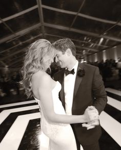 a man and woman in formal wear dancing