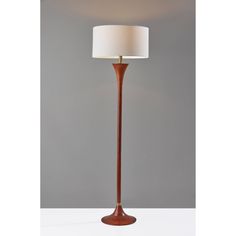 a floor lamp with a white shade on it's base and a brown wooden pole