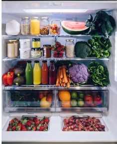 an open refrigerator filled with lots of fresh fruits and vegetables