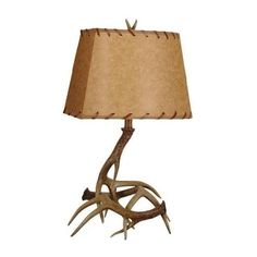 a lamp with antlers on it and a brown shade