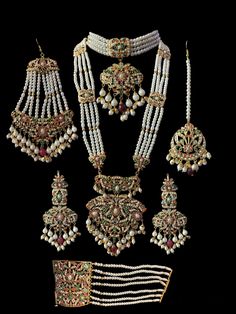 bridal set includes choker , earrings , jhoomar , tika , ring , bracelet and Rani haar made using cz stones , shell pearls , beads and gold plating Kundan Sets With Stone Work For Wedding, Pearl Chandbali Sets With Stone Work, Kundan Bridal Sets With Stone Work For Marriage, Traditional Pearl Jewelry For Marriage, White Sets With Stone Work For Marriage, Rani Haar, Silver Jewelry Earrings, Silver Jewelry Pendant, Jewelry Design Necklace