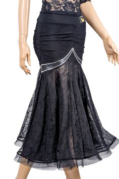 a mannequin wearing a black dress with lace on the top and skirt below