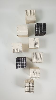 five blocks of wood with black and white lines on them, arranged in the shape of rectangles