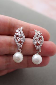 Bridal  Earrings, Art Deco Style Earrings, Bridesmaid Earrings,  Pearl Earrings, Wedding Jewelry, Vintage style Wedding Earrings  Vintage style  earrings  with  pearls Colour: rhodium(silver tone) /clear/ ivory. Measurements: approx 3.3 cm , width approx 10 mm .Pearl size approx 8-9 mm.  Materials:  rhodium components, clear zircon crystals, faux  pearls . Stud earrings. Great for wedding or other celebration. MORE SAME STYLE: https://www.etsy.com/uk/shop/BridalArtDeco?ref=listing-shop-header-it Pearl Drop Dangle Clip-on Earrings For Wedding, Elegant Pierced Cluster Earrings For Wedding, Pearl White Clip-on Earrings For Wedding, Exquisite Dangle Pearl Earrings For Anniversary, Exquisite Pearl Drop Bridal Earrings For Anniversary, Dangle Cluster Earrings For Wedding, Exquisite Dangle Pearl Earrings For Pierced Ears, Exquisite Pearl Drop Bridal Earrings For Wedding, Exquisite Dangle Pearl Earrings For Wedding