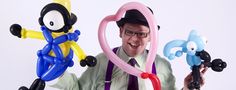 a man is holding three balloons in the shape of cartoon characters