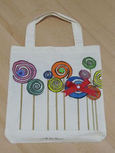 a white bag with colorful lollipops on it