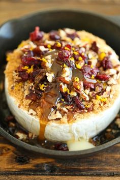 a pan filled with food sitting on top of a wooden table