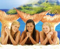 three beautiful young women laying on the beach in front of an image of two seagulls