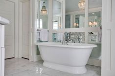 a white bath tub sitting inside of a bathroom