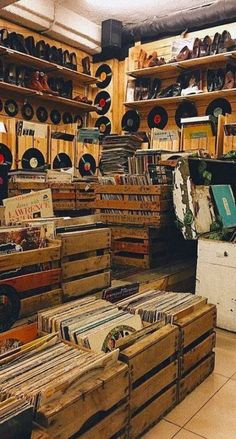 a room filled with lots of wooden boxes and records