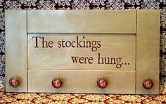 a sign that says the stockings were hung with four knobs on each side