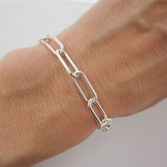 "SOLID 925 STERLING SILVER This unique bracelet is hand-crafted out of solid sterling silver and features a thick and chunky \"paperclip\" style chain. The rectangle links measure approximately 15mm long and 6mm wide. Bracelet is available in your choice of length and closes with an easy-to-use lobster claw clasp. Comes in a gift box. More paperclip bracelets available here: www.etsy.com/shop/TheVioletGoat?ref=seller-platform-mcnav&search_query=paperclip+bracelet SIZING - IMPORTANT: To determine bracelet size, measure snugly around the wrist and add 1 inch. Because this chain has large links, it can be clipped anywhere for an adjustable fit. If you're unsure of size, I recommend sizing up. RETURNS/EXCHANGES: Due to the high cost of materials for this bracelet, I'm unable to accept returns Luxury Rectangular Sterling Silver Chain Bracelet, Sterling Silver Bracelets With Chunky Chain In Oval Link, Everyday Sterling Silver Chunky Chain Bracelet, Sterling Silver Everyday Bracelet With Chunky Link Chain, Sterling Silver Bracelet With Chunky Chain For Everyday, Everyday Sterling Silver Chunky Link Bracelet, Sterling Silver Paperclip Bracelet With Solid Link Construction, Sterling Silver Paperclip Bracelet With Solid Link, Everyday Sterling Silver Bracelet With Chunky Chain