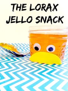 a jar filled with jello sitting on top of a blue and white table cloth