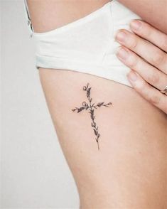 a woman with a cross tattoo on her stomach