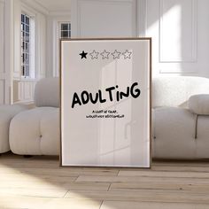 there is a poster on the floor with words about adulting and three stars above it