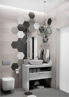 a modern bathroom with hexagonal tiles on the wall