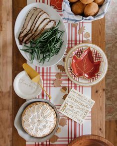 a table topped with plates and bowls filled with food