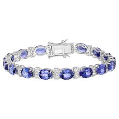 It comes with the Gemological Appraisal by GIA GG/AJP All Gemstones are Natural 17 Oval Tanzanites = 19.55 Carats 51 Diamonds = 0.70 Carats Metal: 14K White Gold Bracelet Length: 7.25 Inches Bracelet Tennis, Bracelet Diamond, Modern Bracelets, Tanzanite Stone, White Gold Bracelet, Yellow Gold Bracelet, Tennis Bracelet Diamond, Diamond Bracelets, Tennis Bracelet