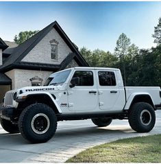 a white jeep parked in front of a house