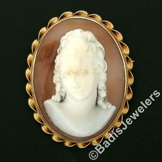 "This unique vintage brooch or pendant was crafted from solid 14k yellow gold. It features a large oval shaped carved shell cameo bezel set at its center. The piece of shell used for this particular carving is very uniquely convex shaped allowing the portrait to have a domed 3D look. That cameo is then surrounded by a pair of twisted wire frames with a finer one on the inside and a much coarser one on the outside.This unique vintage piece remains in excellent and 100% ready to wear upon arrival. Gold Oval Carved Brooches, Oval Carved Gold Brooches, Antique Oval Carved Brooches, 3d Portrait, Carved Shell, Blue Moonstone, Twisted Wire, Wire Frame, Vintage Brooch