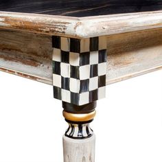 a black and white checkered table top with an old wooden frame on the end