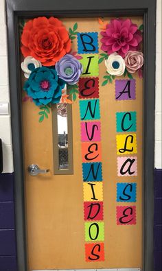 a door decorated with paper flowers and letters