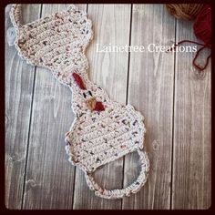 a crocheted bow tie laying on top of a wooden floor