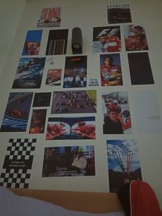 a wall covered in pictures and magnets next to a computer mouse on top of a bed