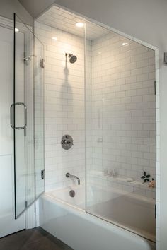 a bathroom with a tub, shower and toilet