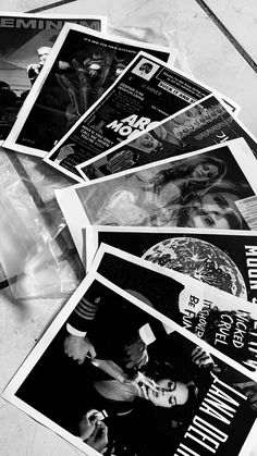 black and white photograph of posters on the floor