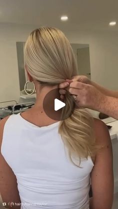 a woman with blonde hair is getting her hair done by an adult in the kitchen