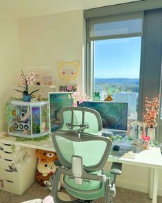 a desk with a computer and stuffed animals in front of a window overlooking the city