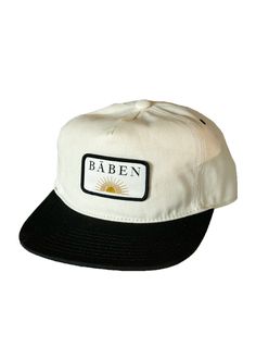 The BĀBEN cap is easy to wear for days spent in the sun. The hat is a mid-profile unstructured 5 panel cap cut in cotton canvas. It features an adjustable fit with a metal slider closure and a woven patch logo. Keeping it neutral with a two-tone creme and black colorway, it is versatile and perfect for salty hair days. Vintage pin not included. Fabric & Care Instructions: 100% Cotton Canvas Adjustable Snapback Hat With Curved Bill For Everyday, Adjustable Trucker Hat For Everyday Summer Use, Adjustable Canvas Snapback Hat With Flat Bill, Everyday Adjustable Snapback Hat With Curved Bill, Adjustable Canvas Hat With Logo Patch, Summer Everyday Snapback Hat With Curved Brim, Cotton 5-panel Trucker Hat With Logo Patch, Adjustable Cotton Snapback Hat For Beach, Summer 5-panel Trucker Hat For Everyday Wear