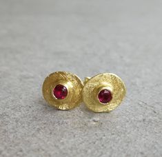 Vintage style gold earrings with tiny red Ruby 14K Gold earrings Yellow gold  Gold dainty earrings Gold stud earrings Everyday earrings Small gold stud earrings with red ruby. This is the perfect everyday earrings, it features a small raw gold disc and a small ruby stone. An excellent choice for anniversary gift or birthday gift for her. ★DETAILS: *Material you can choose: 14k, 9k solid gold. *Red Ruby: 3mm *Disk diameter approx. 8 mm *Butterfly backs included. *Matte finish. ★All my products are handmade and designed by me. *All jewelry comes in a nice package and ready to give as gift. *For any questions, custom order & special requests, please feel free to contact with me. For more earrings: https://www.etsy.com/shop/Arju?ref=seller-platform-mcnav§ion_id=7959855