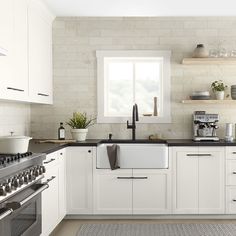 a kitchen with white cabinets and black counter tops, including a dishwasher in the center