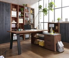 an office with lots of shelves and desks in front of a large window that looks out onto the city