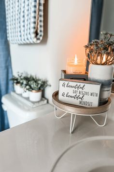 a bathroom with a candle and some decorations on the counter top in front of a mirror