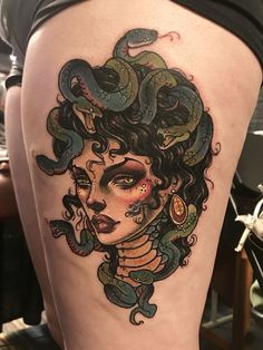 a woman with snakes on her thigh is shown in this tattoo art photo by artist mark st