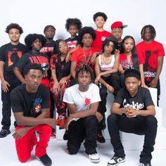 a group of young men and women posing for a photo in front of a white background